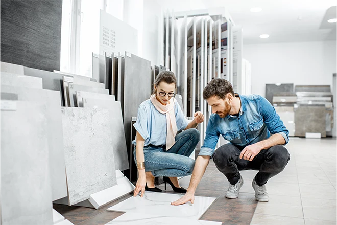 Designer and man looking at bathroom remodeling materials