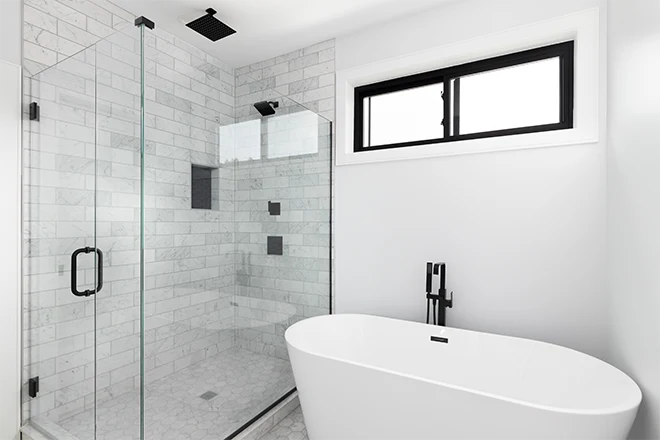 White bathroom with tub and glass walk in shower