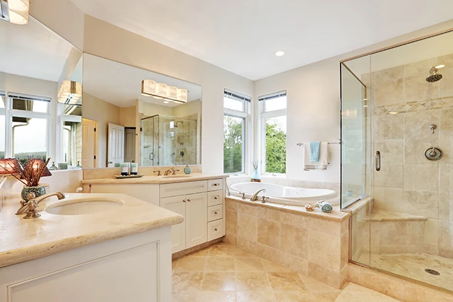 A primary bathroom with beige tile